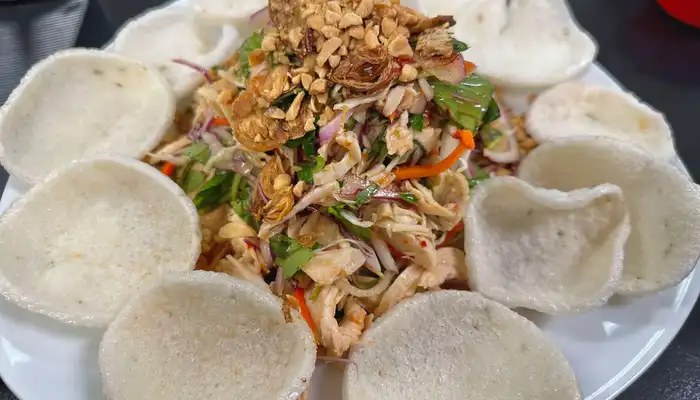 Hana Pho Vietnamese salad piled high with herbs, peanuts and fried shallots, served with shrimp chips